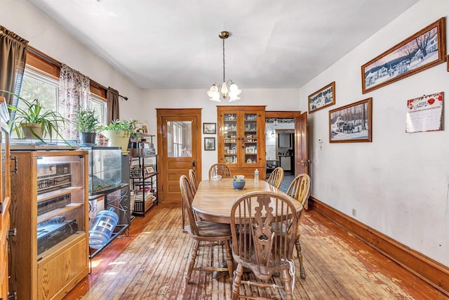 823 N Main St, Marion, WI 54950 - dining space with wood-type flooring, a chandelier, and baseboards