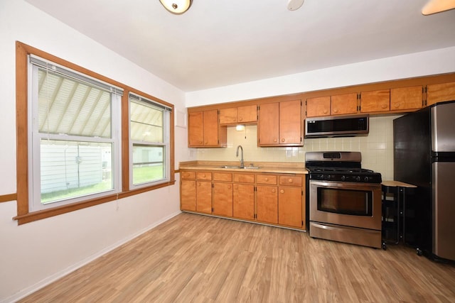 3825 S 5th St Unit 3823, Milwaukee, WI 53207 - kitchen featuring appliances with stainless steel finishes, a sink, light countertops, and light wood finished floors