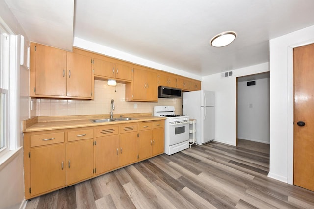 3825 S 5th St Unit 3823, Milwaukee, WI 53207 - kitchen featuring white appliances, a sink, light wood-type flooring, backsplash, and light countertops