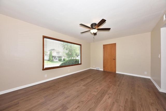 3825 S 5th St Unit 3823, Milwaukee, WI 53207 - spare room featuring dark wood-style floors, ceiling fan, and baseboards