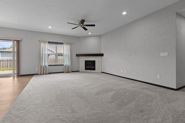 W6008 Zach St, Menasha, WI 54952 - unfurnished living room with plenty of natural light, ceiling fan, recessed lighting, baseboards, and a fireplace