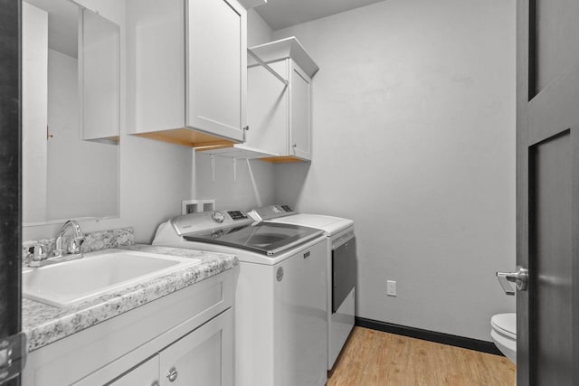 W6008 Zach St, Menasha, WI 54952 - washroom with washer and clothes dryer, light wood-type flooring, and baseboards