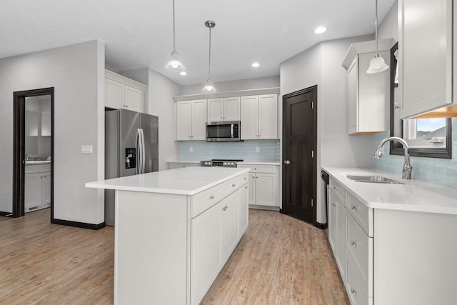 W6008 Zach St, Menasha, WI 54952 - kitchen with stainless steel appliances, a sink, tasteful backsplash, light wood-type flooring, and recessed lighting
