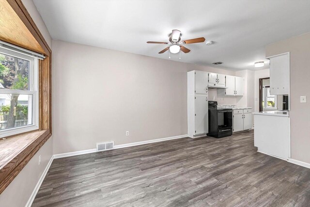 230 S Washington Ave, Waukesha, WI 53188 - kitchen with black / electric stove, dark wood-type flooring, a ceiling fan, light countertops, and white cabinetry