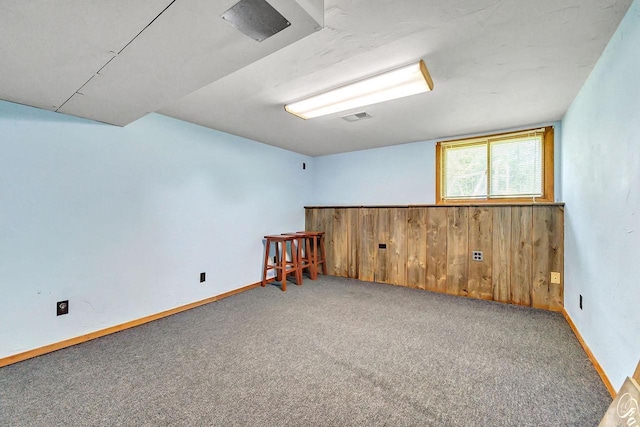 718 Fathom Pl, Sturgeon Bay, WI 54235 - carpeted spare room featuring wooden walls and baseboards