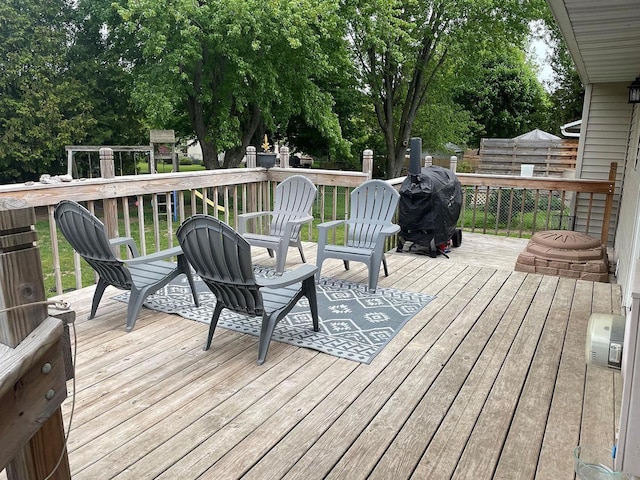 718 Fathom Pl, Sturgeon Bay, WI 54235 - wooden deck with view of scattered trees, area for grilling, and a playground
