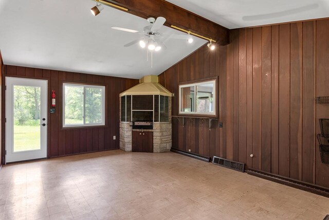 2373 State Road 33, Saukville, WI 53080 - unfurnished living room with tile patterned floors, wooden walls, and ceiling fan