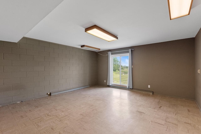 2373 State Road 33, Saukville, WI 53080 - unfurnished room featuring a baseboard radiator, light flooring, and concrete block wall