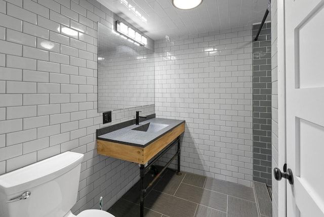 2373 State Road 33, Saukville, WI 53080 - bathroom with tile walls, a sink, toilet, and tile patterned floors