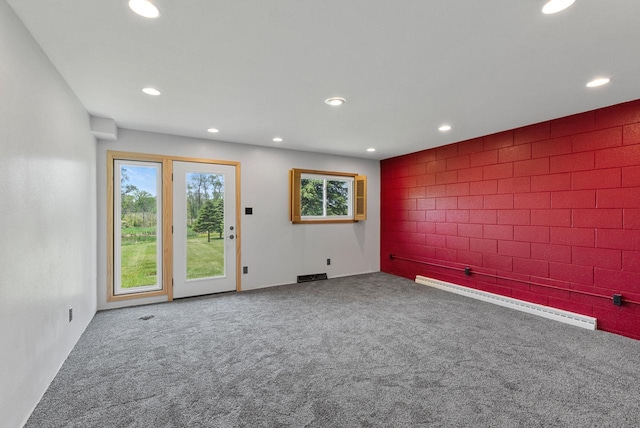2373 State Road 33, Saukville, WI 53080 - carpeted empty room featuring a baseboard radiator, recessed lighting, and tile walls