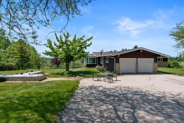 2373 State Road 33, Saukville, WI 53080 - ranch-style home with a front lawn, a garage, and asphalt driveway