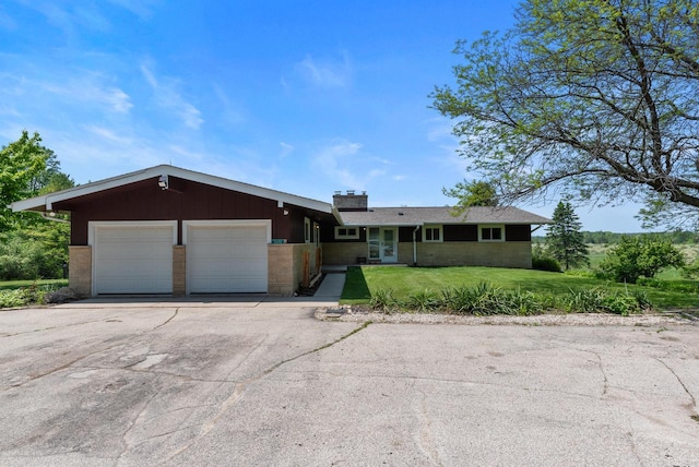 2373 State Road 33, Saukville, WI 53080 - ranch-style home with a front yard, an attached garage, brick siding, and asphalt driveway