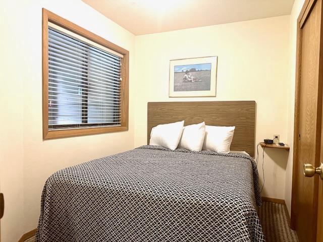 7741 State Highway 42 Unit 105, Egg Harbor, WI 54209 - bedroom with baseboards and a closet