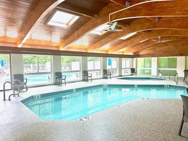 7741 State Highway 42 Unit 105, Egg Harbor, WI 54209 - indoor community pool featuring a skylight