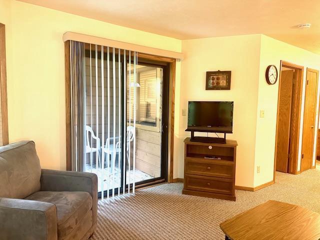 7741 State Highway 42 Unit 105, Egg Harbor, WI 54209 - sitting room with light colored carpet and baseboards