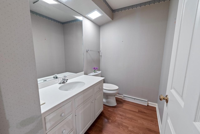 10109 N Gettysburg Ct, Mequon, WI 53092 - half bathroom with a baseboard heating unit, wood finished floors, and vanity