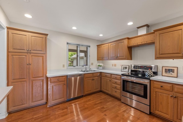 10109 N Gettysburg Ct, Mequon, WI 53092 - kitchen featuring appliances with stainless steel finishes, light countertops, light wood finished floors, and recessed lighting