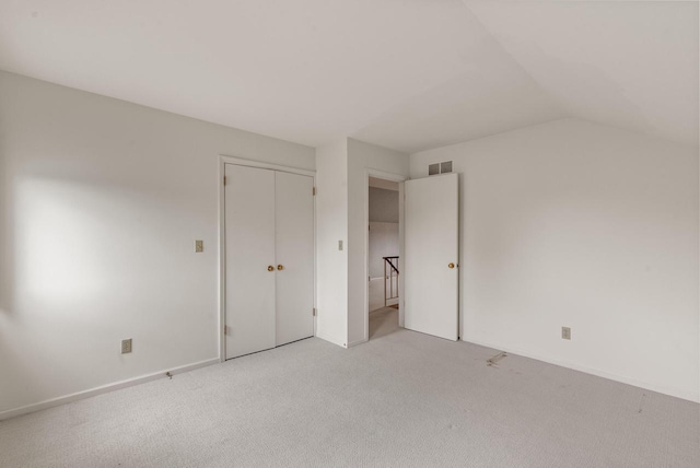10109 N Gettysburg Ct, Mequon, WI 53092 - unfurnished bedroom with light carpet, lofted ceiling, and a closet