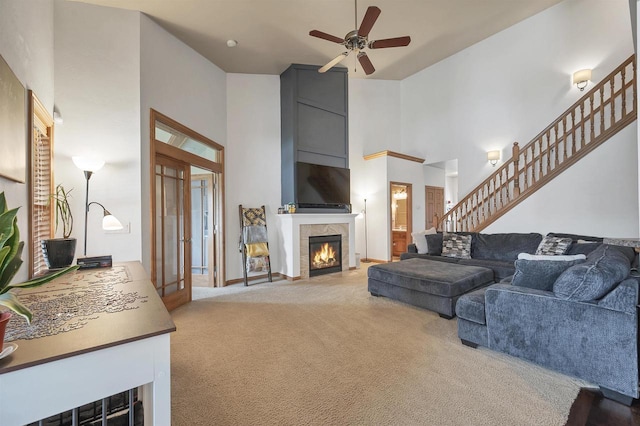 2527 W Crais Ct, De Pere, WI 54115 - living room featuring carpet, ceiling fan, a towering ceiling, a fireplace, and stairs