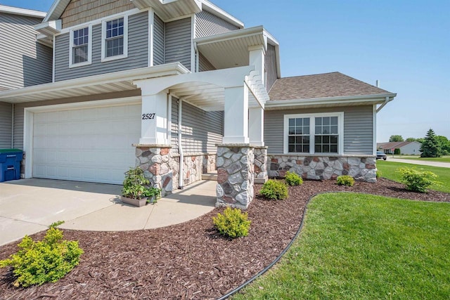2527 W Crais Ct, De Pere, WI 54115 - craftsman-style home featuring stone siding, a shingled roof, driveway, an attached garage, and a front yard