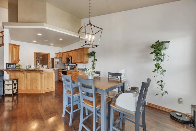 2527 W Crais Ct, De Pere, WI 54115 - dining area featuring dark wood-type flooring, a chandelier, a towering ceiling, baseboards, and recessed lighting