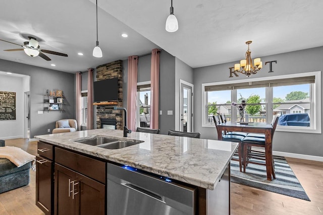 W5706 Mase Ct, Appleton, WI 54915 - kitchen featuring dishwasher, a sink, open floor plan, a chandelier, and a fireplace