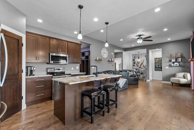 W5706 Mase Ct, Appleton, WI 54915 - kitchen with appliances with stainless steel finishes, open floor plan, ceiling fan, recessed lighting, and an island with sink