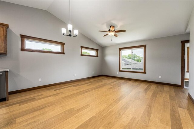 2837 Patrick John Dr, Eau Claire, WI 54703 - empty room featuring lofted ceiling, a ceiling fan, light wood finished floors, a chandelier, and baseboards