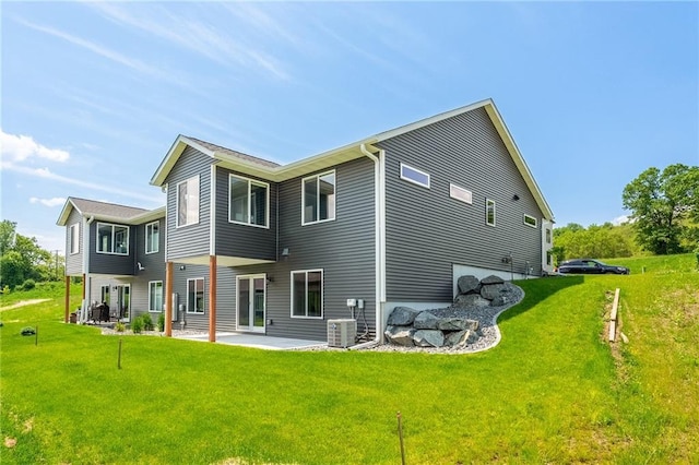 2837 Patrick John Dr, Eau Claire, WI 54703 - rear view of house featuring a patio area, a lawn, and central AC