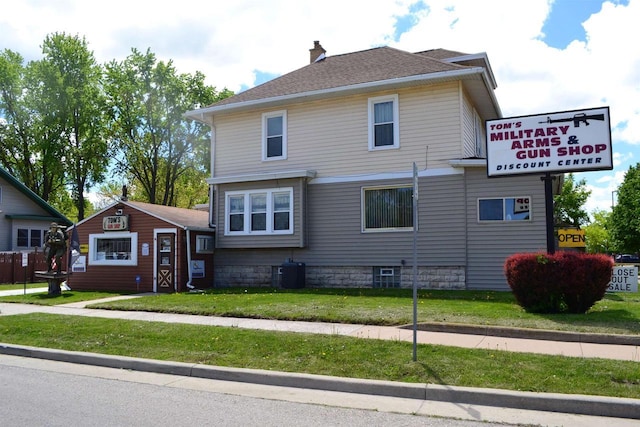 355 N Main St, Fond Du Lac, WI 54935 - view of front of house featuring cooling unit, a front yard, a chimney, and roof with shingles