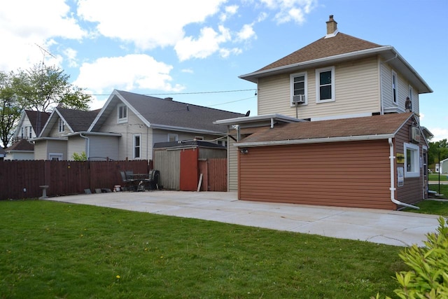355 N Main St, Fond Du Lac, WI 54935 - back of house with a patio, a chimney, a garage, concrete driveway, and cooling unit
