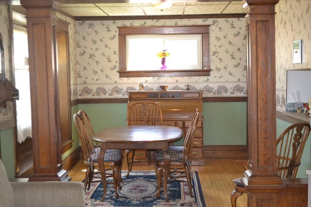 355 N Main St, Fond Du Lac, WI 54935 - dining room with decorative columns, wallpapered walls, light wood finished floors, and wainscoting