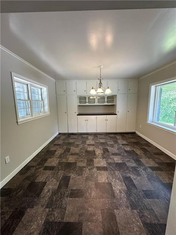 332 E Pleasant Ave, Ellsworth, WI 54011 - unfurnished dining area with baseboards and ornamental molding