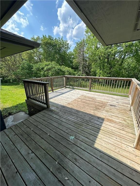 332 E Pleasant Ave, Ellsworth, WI 54011 - wooden terrace with a yard and view of wooded area