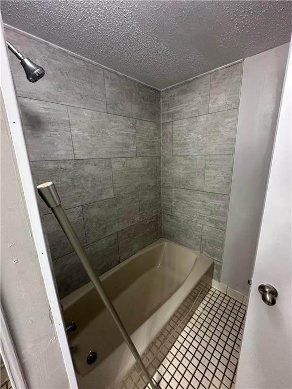 332 E Pleasant Ave, Ellsworth, WI 54011 - bathroom with a textured ceiling,  shower combination, and tile patterned flooring