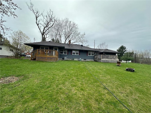 332 E Pleasant Ave, Ellsworth, WI 54011 - back of property with a deck, a yard, and an outdoor fire pit