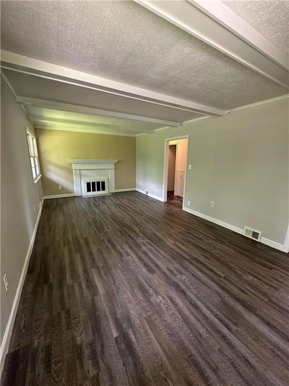 332 E Pleasant Ave, Ellsworth, WI 54011 - unfurnished living room featuring beamed ceiling, dark wood finished floors, baseboards, a fireplace, and a textured ceiling