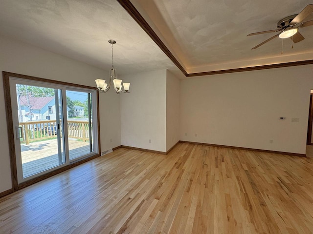 1511 16th Ave, Monroe, WI 53566 - empty room with a chandelier, light wood finished floors, baseboards, and ceiling fan