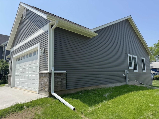1511 16th Ave, Monroe, WI 53566 - view of home's exterior with a garage, a lawn, stone siding, and concrete driveway