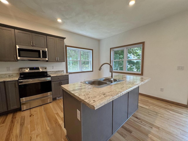 1511 16th Ave, Monroe, WI 53566 - kitchen featuring stainless steel appliances, a sink, light wood-style floors, light countertops, and recessed lighting