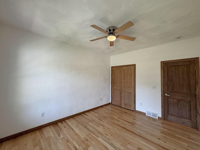 1511 16th Ave, Monroe, WI 53566 - unfurnished bedroom featuring light wood finished floors, baseboards, ceiling fan, and a closet
