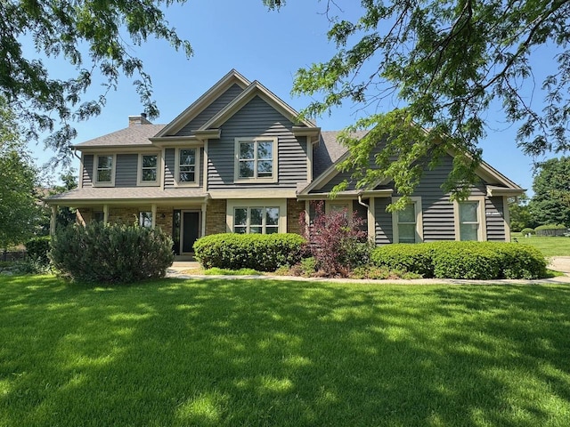 N49W31242 Old Steeple Rd, Hartland, WI 53029 - view of front of home with a front lawn, a chimney, and roof with shingles