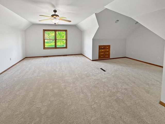 N49W31242 Old Steeple Rd, Hartland, WI 53029 - additional living space with vaulted ceiling, baseboards, a ceiling fan, and carpet flooring