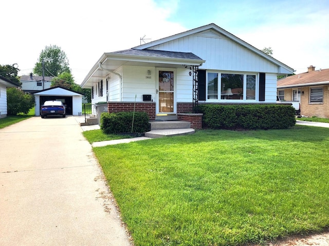 3843 S 95th St, Milwaukee, WI 53228 - bungalow-style house featuring a front lawn, driveway, a garage, an outbuilding, and brick siding