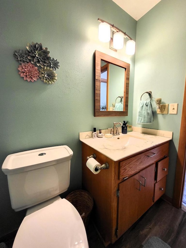 3843 S 95th St, Milwaukee, WI 53228 - half bath featuring toilet, vanity, and wood finished floors