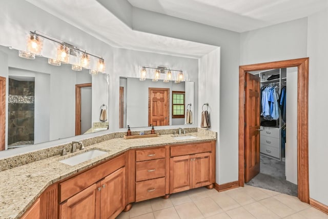 W226N3550 Wethersfield Rd, Pewaukee, WI 53072 - full bathroom featuring double vanity, tile patterned flooring, a tile shower, and a walk in closet