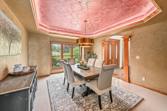 W226N3550 Wethersfield Rd, Pewaukee, WI 53072 - dining room with a tray ceiling, a textured wall, decorative columns, and baseboards