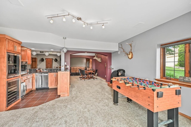 W226N3550 Wethersfield Rd, Pewaukee, WI 53072 - recreation room featuring wine cooler, arched walkways, dark colored carpet, and baseboards