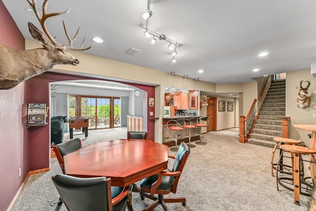 W226N3550 Wethersfield Rd, Pewaukee, WI 53072 - dining space featuring light carpet, stairs, baseboards, recessed lighting, and arched walkways