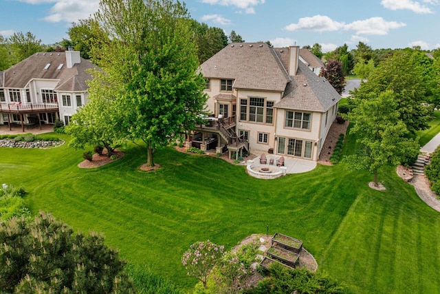 W226N3550 Wethersfield Rd, Pewaukee, WI 53072 - back of house with a fire pit, a patio area, a deck, stairs, and a lawn